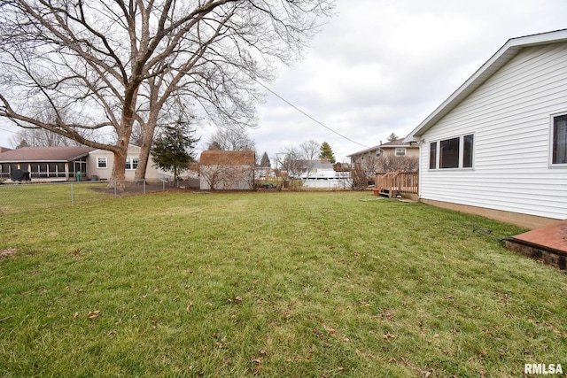 view of yard with a wooden deck and fence