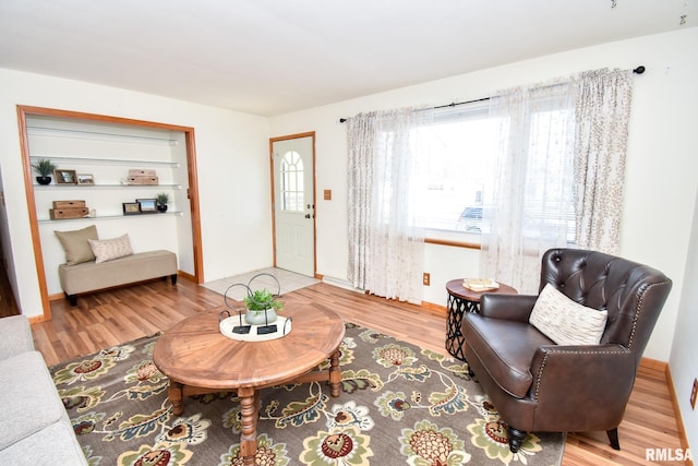 living area featuring a wealth of natural light and wood finished floors