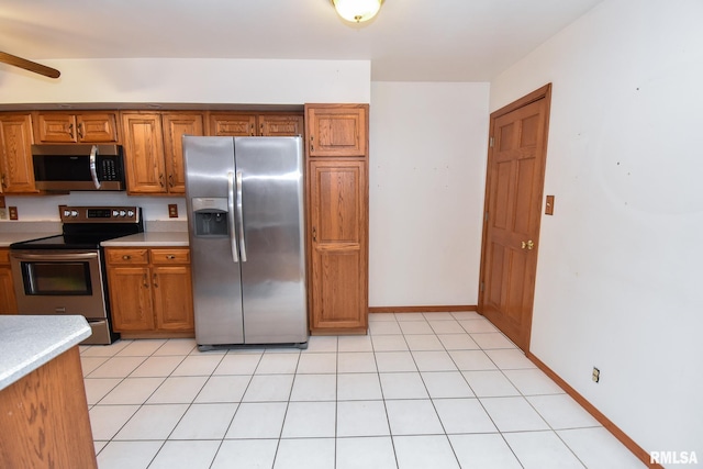 kitchen featuring light tile patterned flooring and stainless steel appliances