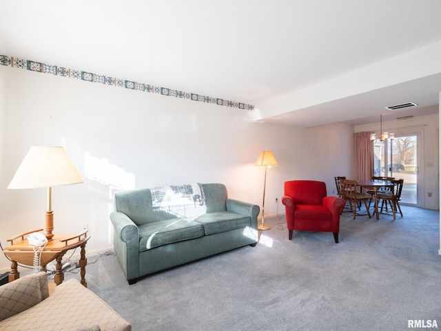 living room featuring carpet and a chandelier