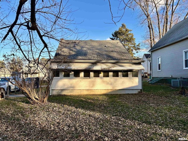 exterior space featuring a lawn and central AC unit