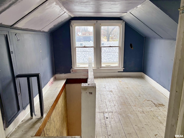 bonus room featuring light hardwood / wood-style floors and vaulted ceiling