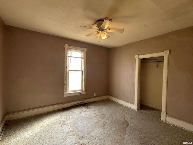 unfurnished bedroom with a closet, carpet flooring, and ceiling fan