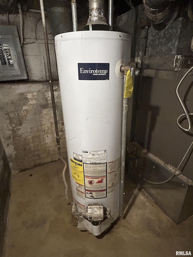 utility room featuring electric panel and gas water heater