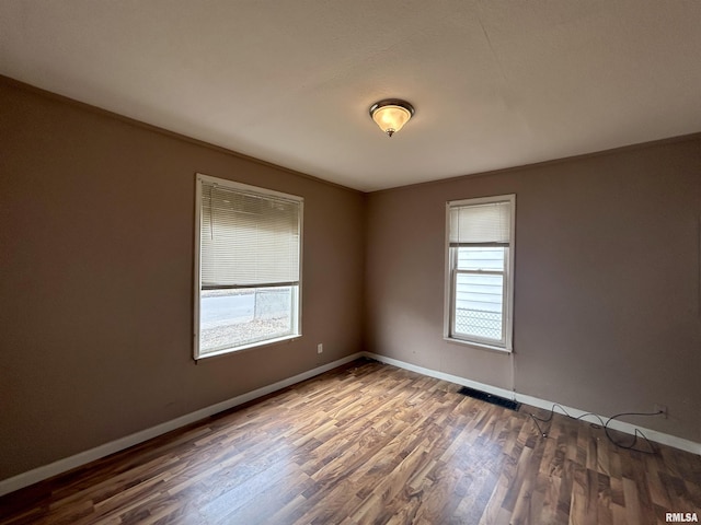 empty room featuring dark hardwood / wood-style flooring