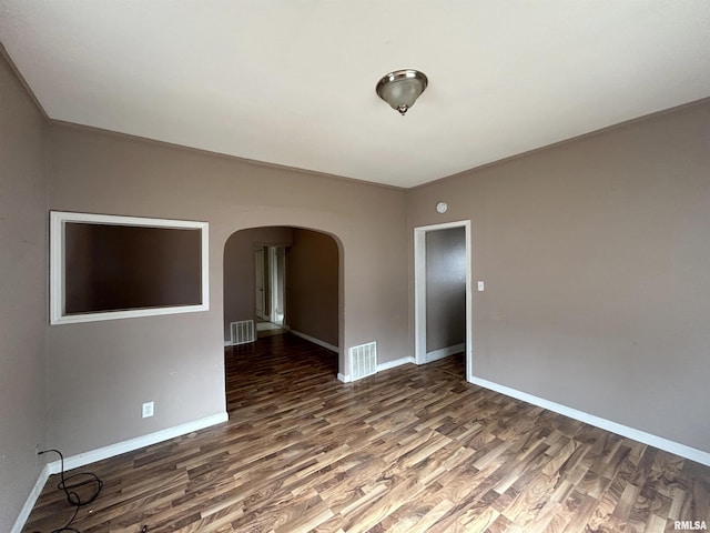 empty room with dark hardwood / wood-style flooring