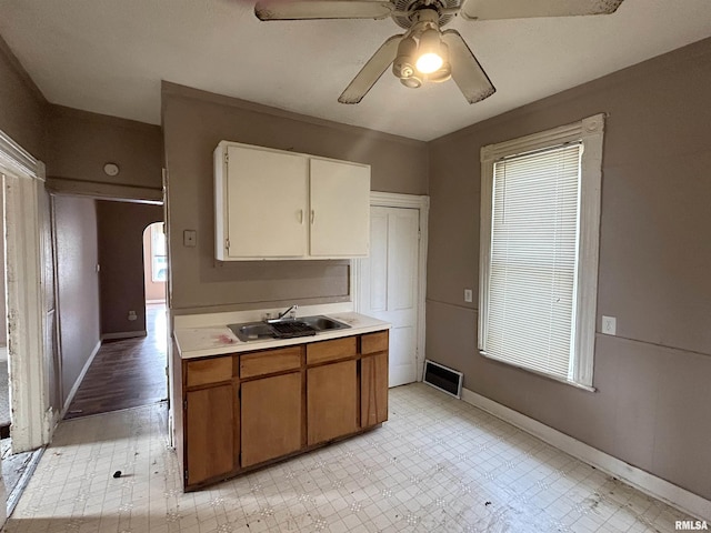 kitchen featuring ceiling fan and sink