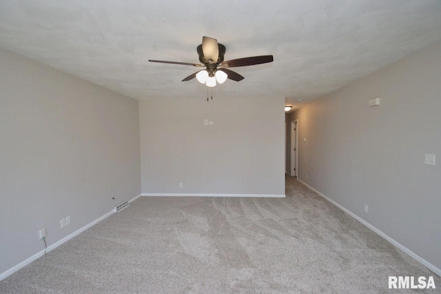 empty room featuring ceiling fan and light colored carpet