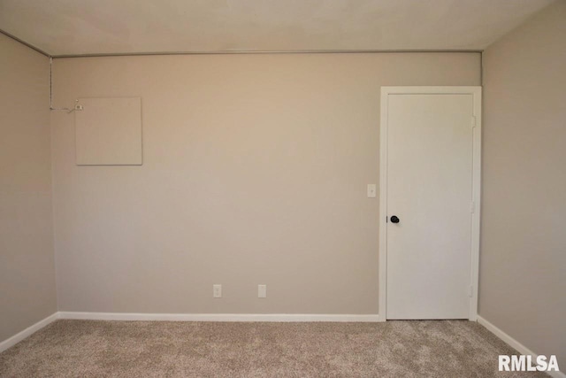 spare room featuring light colored carpet