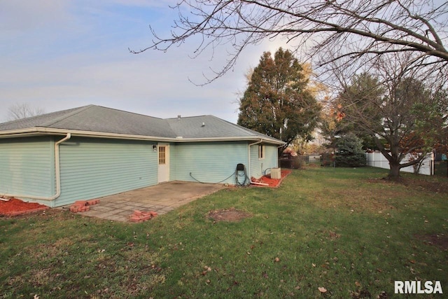 rear view of property with a yard and a patio area