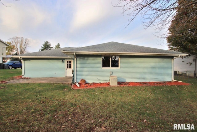 rear view of property featuring a yard