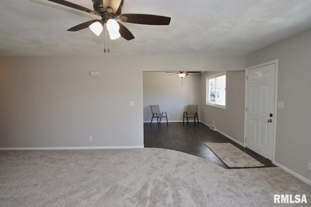 carpeted spare room featuring ceiling fan