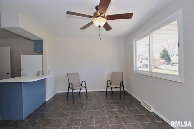 living area featuring ceiling fan