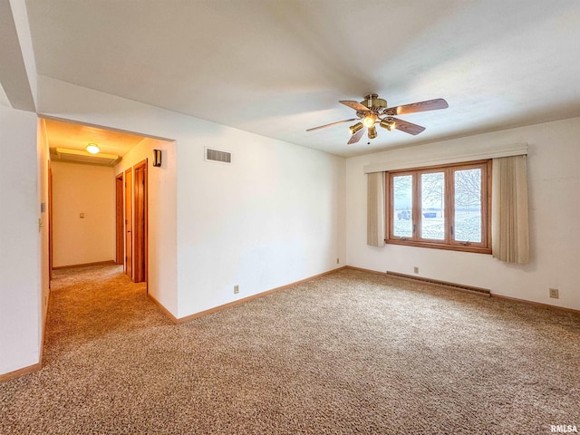 carpeted spare room featuring ceiling fan and a baseboard radiator