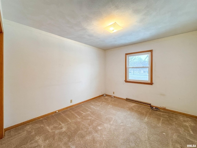 unfurnished room with carpet flooring, a baseboard radiator, and a textured ceiling