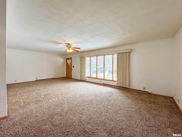 empty room featuring a textured ceiling, carpet floors, ceiling fan, and a baseboard heating unit