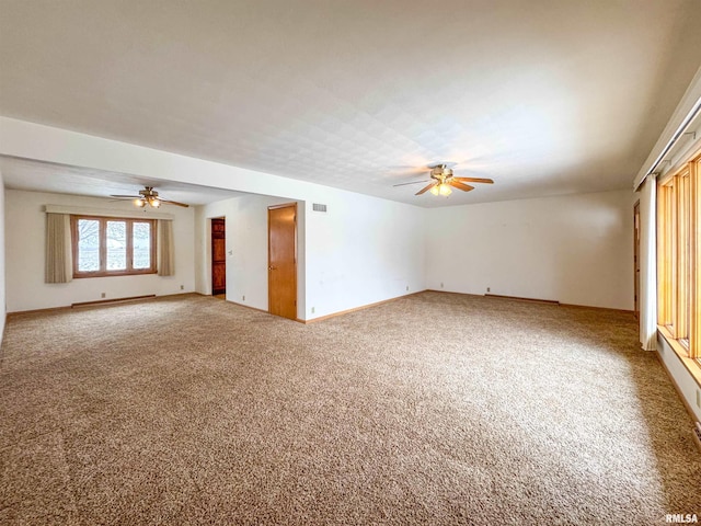 carpeted empty room featuring baseboard heating and ceiling fan