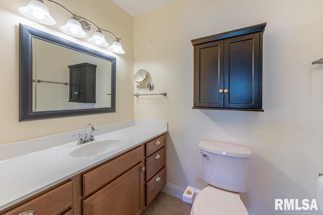 bathroom featuring tile patterned flooring, vanity, and toilet