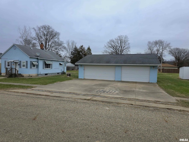 view of front of property featuring a garage and a front yard