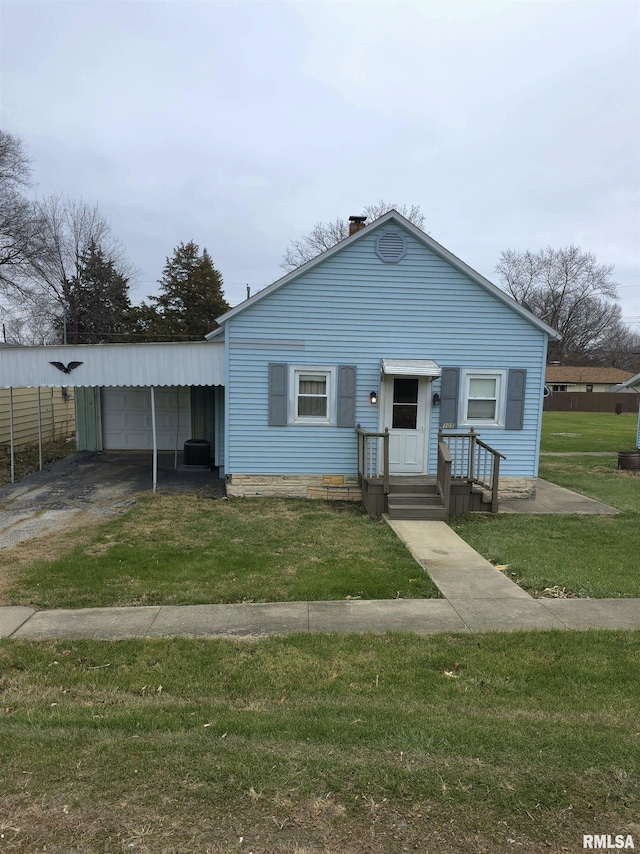 bungalow featuring a garage and a front lawn