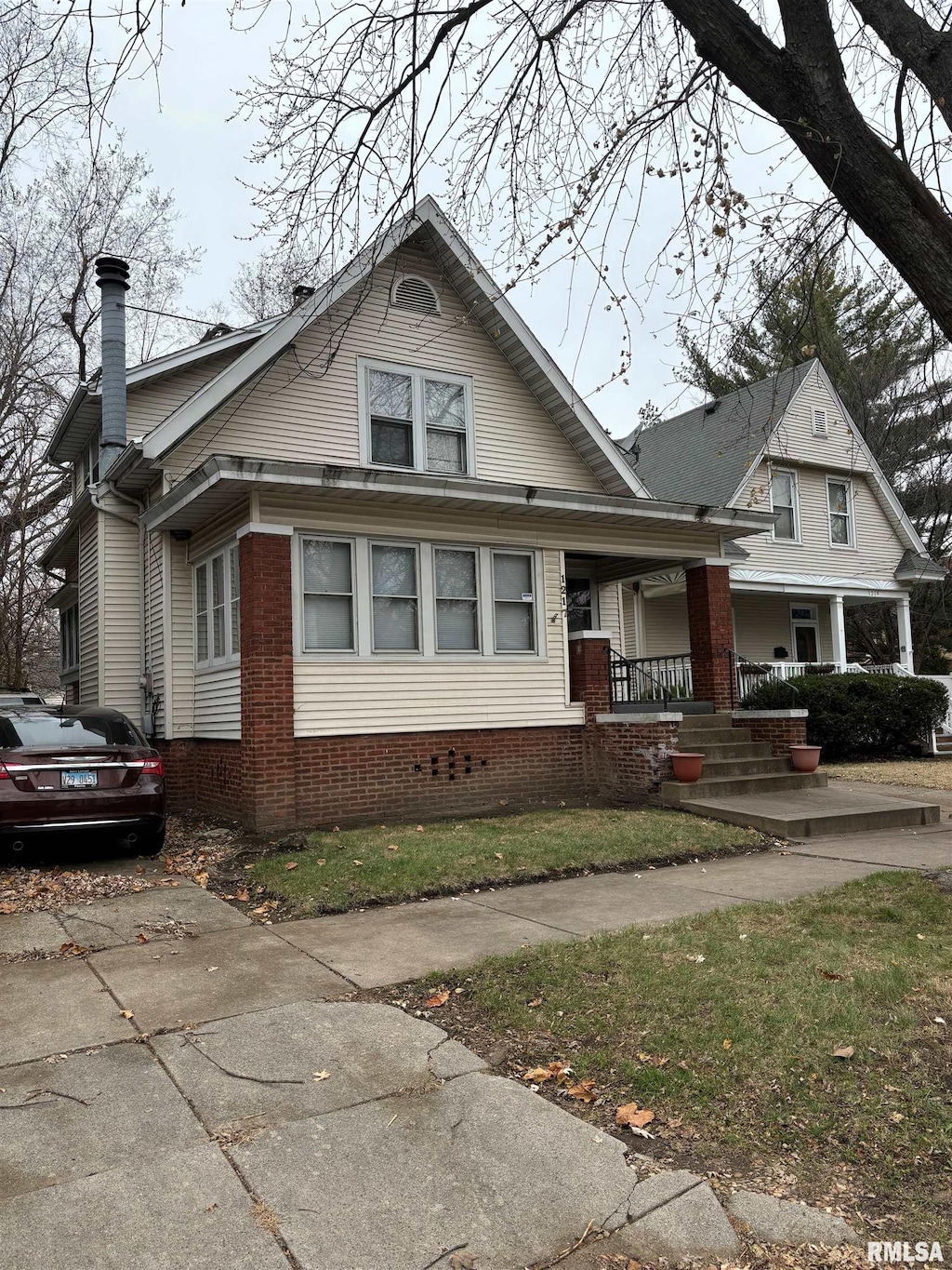 bungalow featuring covered porch and a chimney