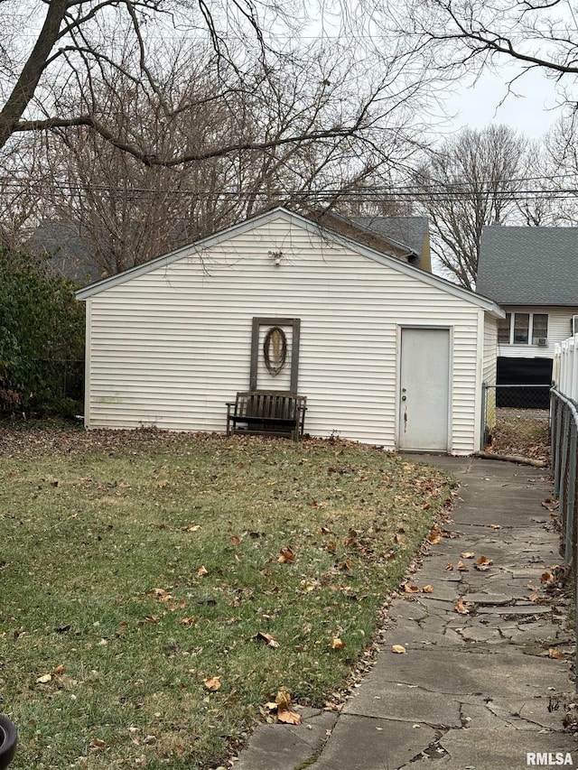 view of outdoor structure featuring a lawn