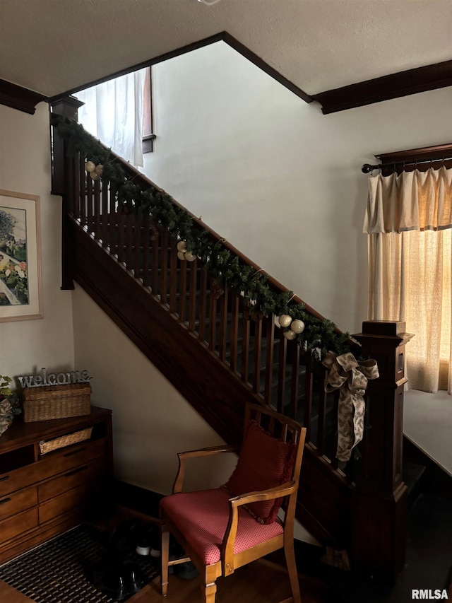 stairway with a textured ceiling