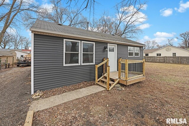 view of exterior entry with a lawn