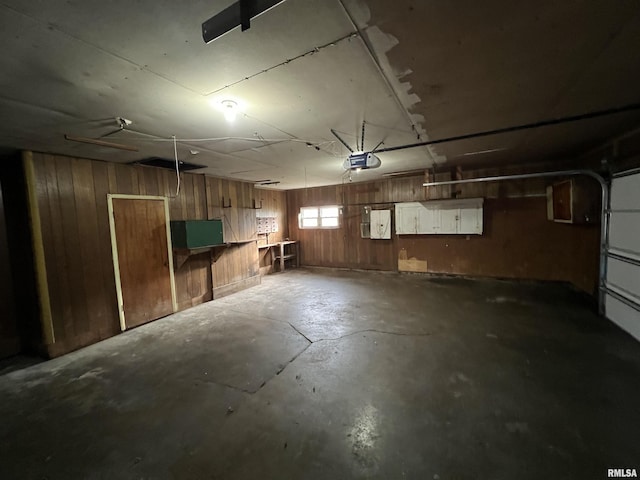 basement featuring wood walls