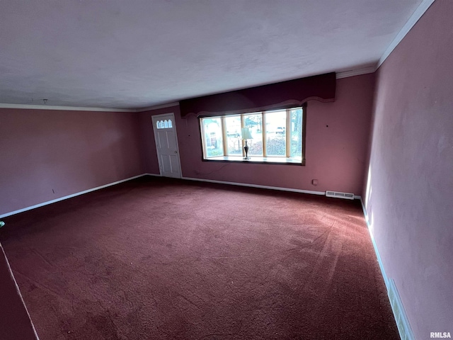 unfurnished room with crown molding and carpet