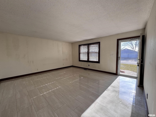 spare room with a textured ceiling