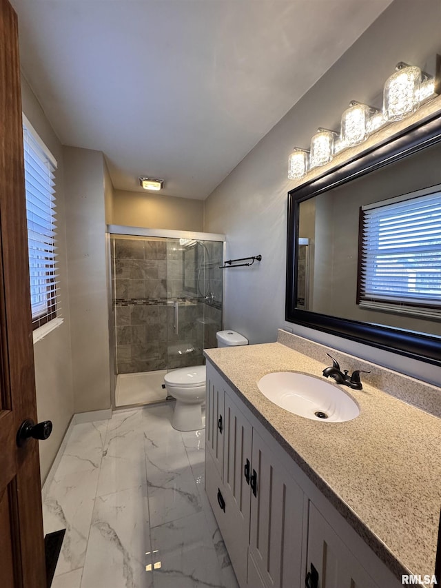 bathroom with vanity, toilet, and an enclosed shower