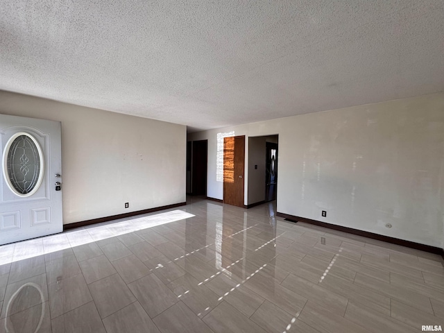 empty room featuring a textured ceiling