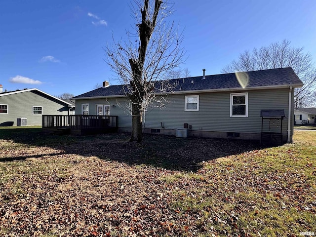 back of house with cooling unit, a yard, and a wooden deck