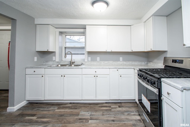 kitchen with white cabinetry, sink, dark wood-type flooring, and stainless steel range with gas stovetop