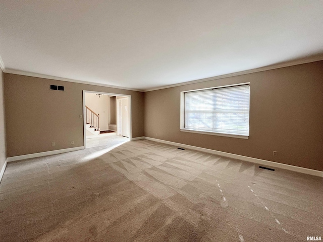 carpeted empty room featuring ornamental molding