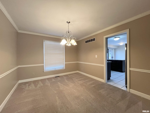 carpeted empty room featuring crown molding and an inviting chandelier