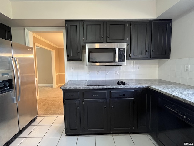 kitchen with decorative backsplash, light stone counters, ornamental molding, black appliances, and light tile patterned floors