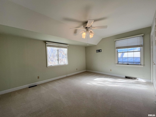 carpeted empty room featuring ceiling fan and lofted ceiling