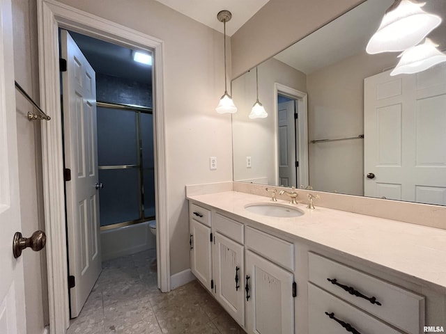 bathroom with shower / bath combination with glass door and vanity