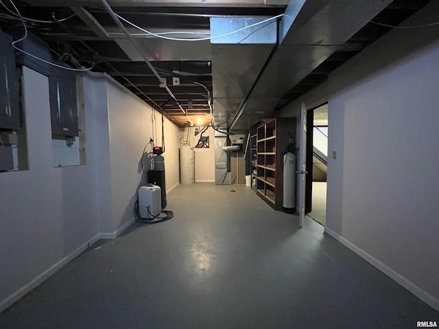 basement featuring gas water heater and electric panel