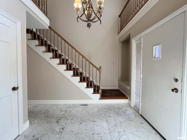 entrance foyer featuring a high ceiling and a chandelier