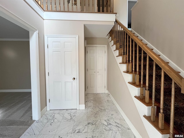 stairway featuring carpet and crown molding