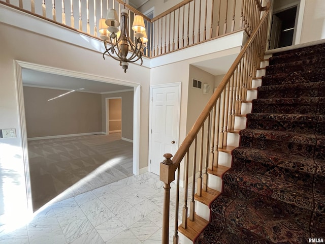 stairway featuring carpet flooring, ornamental molding, a high ceiling, and an inviting chandelier