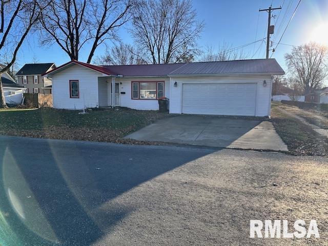 ranch-style home with a garage and a front yard