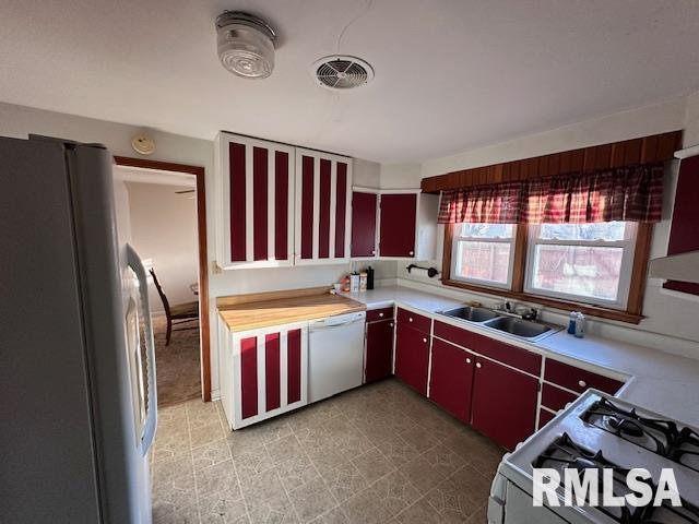 kitchen featuring white appliances and sink