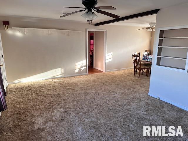 spare room with carpet flooring, ceiling fan, and beam ceiling