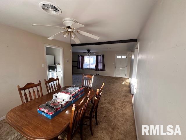 carpeted dining space featuring ceiling fan