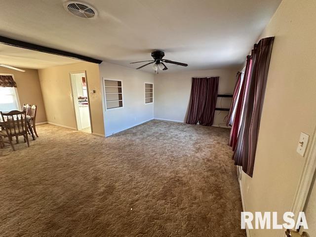 interior space with ceiling fan