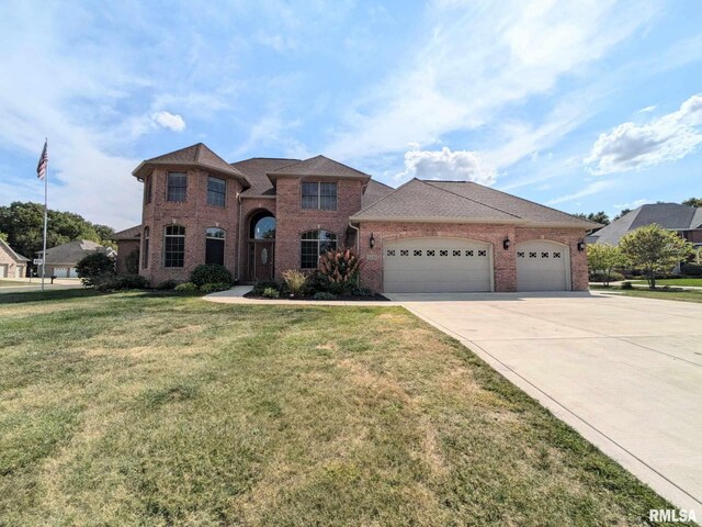 view of front of home featuring a garage and a front lawn